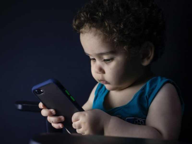 Toddler looking at a smartphone